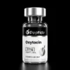 Close-up of a glass vial with a silver cap on a black background; label shows Oxytocin peptide, 2 mg, purity ≥99%, for research use only.
