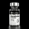 Close-up of a glass peptide vial with a black label reading 'Peptide' and dosage/purity details for research use only.